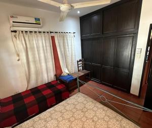 a room with a bed and a couch and a cabinet at La Gloria in Paso de la Patria +4 photos