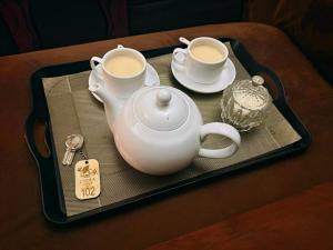 a tray with two cups of coffee on a table at Liora Lodge Ella in Ella