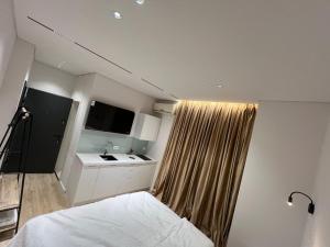 une petite chambre avec un lit et un lavabo dans l'établissement Tirana Square Apartments, à Tirana
