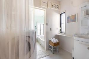 a bathroom with a shower and a sink and a tub at Blodge Lodge in Wazuka +55 photos