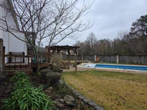 a backyard with a pool and a gazebo and a swimming pool at Walk to Augusta National with Pool, Housekeeper, and Utilities Included in Augusta
