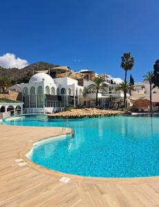 a large swimming pool in front of a building at CASA PERSEA in Nerja