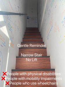 新山Sweet Loft Homestay的楼梯间，墙上写着字，还有楼梯
