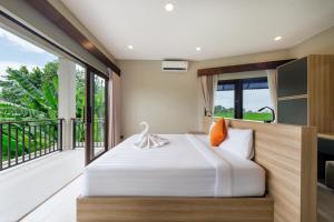 a bedroom with a bed and a balcony at Uma Dauh Villa - Cemagi in Munggu