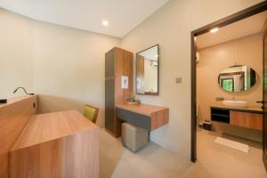 a bathroom with a sink and a mirror at Uma Dauh Villa - Cemagi in Munggu +45 photos