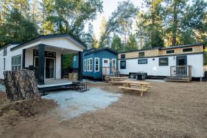 a couple of tiny homes parked in a field at Tiny Blue at Yosemite Gateway in Groveland