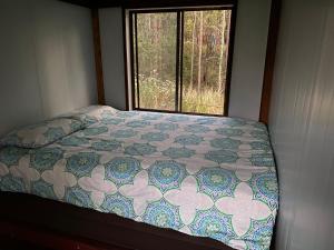 a bed in a small room with a window at Soulhaven at Bentley in Bentley