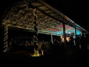 a group of people sitting under a tent with lights at Soulhaven at Bentley in Bentley