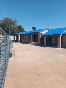 a row of houses with blue roofs at Shayas Haven in Thohoyandou