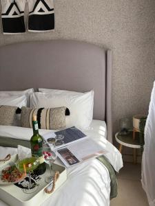 a hotel room with a tray of food on a bed at Shayas Haven in Thohoyandou