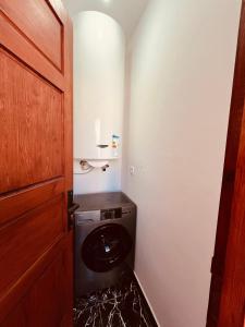 a washer and dryer in a small bathroom at hostel riad maqam in Essaouira +80 photos