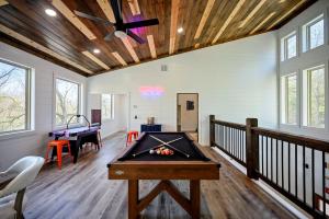 a pool table in a room with a ping pong ball at Chillax Inn The River For 19 in Broken Bow