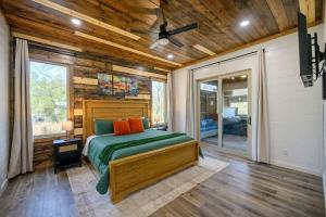 a bedroom with a bed and a ceiling fan at Chillax Inn The River For 19 in Broken Bow