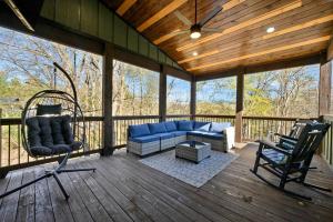 a screened in porch with a blue couch and chairs at Chillax Inn The River For 19 in Broken Bow