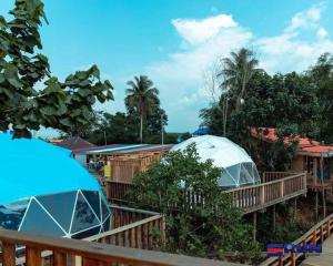 a couple of tents sitting on a deck at Chi Phat River lodge in Chi Phat