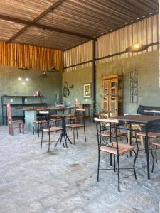 a group of tables and chairs in a room at Pousada e Flat Royal 04 in Itapecerica +14 photos
