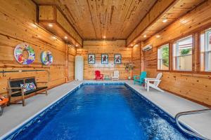 a pool in a log house with wooden walls at Soaring Views Lodge in Sevierville