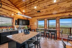 a kitchen with wooden ceilings and a counter with bar stools at Soaring Views Lodge in Sevierville