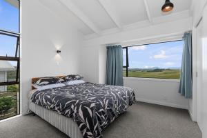 En eller flere senge i et værelse på Mania Views - Waipu Holiday Home
