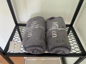 two pairs of socks on a shelf in a room at รักกันต์ รีสอร์ท in Ban Sakat Namman