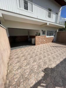 a house with a stone patio in front of it at Residencial Parque Santa Bárbara in Campinas