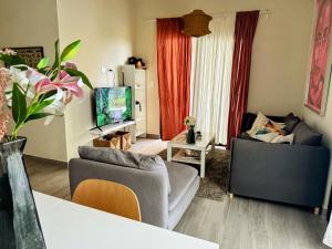 een woonkamer met een bank en een tv bij Family paradise in Punta Cana in Punta Cana