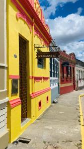 a yellow building with a sign on the side of it at Casa no coração de Areia in Areia +19 photos