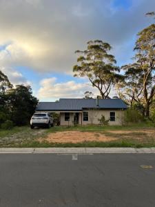 a house with a car parked in front of it at Happy Mountain House in Blackheath