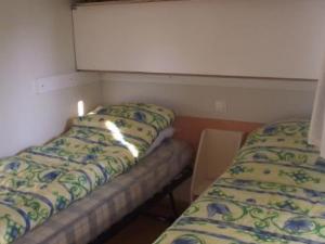 Giường trong phòng chung tại Mobil-home confortable avec terrasse à Bieuzy - API-1-52-1307