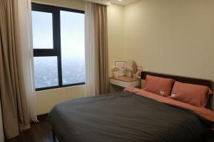 a bedroom with a bed and a large window at Hoàng Huy Commerce Võ Nguyên Giáp Enny Homestay in An Khê +32 photos