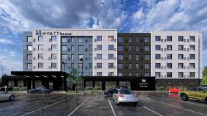 a hotel with cars parked in a parking lot at Hyatt House Thunder Bay in Thunder Bay