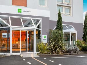 an entrance to a building with glass doors at ibis Styles Colombes Paris Ouest (Ouverture Octobre 2025) in Colombes