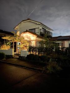 a house with lights on the front of it at 最大10名 源泉掛け流し露天風呂付き一棟貸しNagasima Private Villa in Genroku