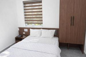a bedroom with a bed and a wooden cabinet at 72M Hotel Visip in Vinh