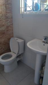 a bathroom with a toilet and a sink at Jamaica Beach in Tower Isle +6 photos