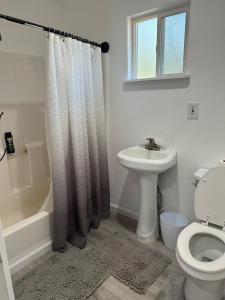 a white bathroom with a toilet and a sink at Yosemite Gateway home in Groveland in Groveland +22 photos