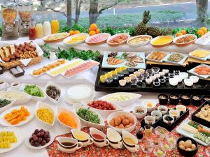 a table filled with lots of different types of food at Hotel Crown Palais Kitakyushu in Kitakyushu