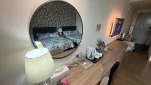 a bedroom with a bed and a large mirror at AbahHomeStudio Tunjung in Kota Bharu