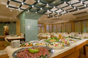 a buffet line with plates of food on a table at Termeterna Resort in Abano Terme