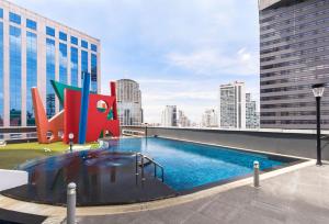a swimming pool on the roof of a building at S31 Sukhumvit Hotel in Bangkok