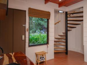 a room with a window and a stair case at Nido de Montaña in Fraijanes +10 photos