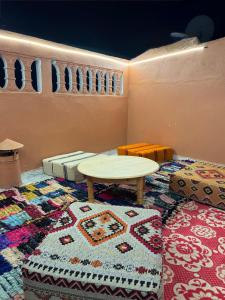 a room with a table and a rug at Entire Guesthouse with Private Rooftop in Taghazout