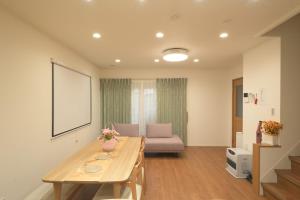 a living room with a table and a couch at Peace and Harmony House Rongsheng in Nagoya