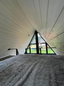a bed in a tent with a large window at Серце Карпат in Skole +13 photos