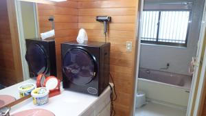 a bathroom with a washing machine on a counter at Tsumugu dom in Ueda +76 photos