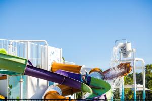 a water park with a water slide in front of a building at BIG4 Adventure Whitsunday Resort in Airlie Beach