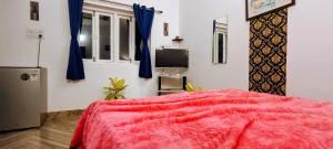 - une chambre avec une couverture rouge sur un lit dans l'établissement GS Home on the Bay - Sea view room, à Vagator