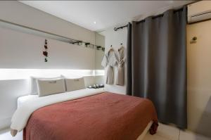 a bedroom with a bed with a red blanket at The Lime Hotel in Incheon +8 photos