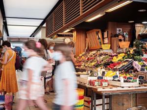a group of people walking through a market at ibis Montpellier Centre Comedie in Montpellier