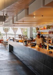 a chef preparing food in a restaurant kitchen at The Lodge Wadjemup in Rottnest Island